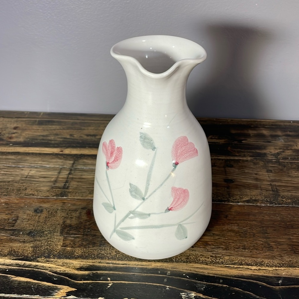 Pottery vessel with pouring spout.  Whimsical floral pattern.